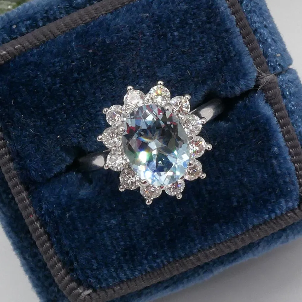 Oval Aquamarine and Diamond Halo Engagement Ring